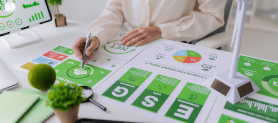 woman with ESG posters and charts on desk